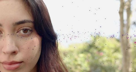 Closeup portrait young woman gazing with colorful speckles overlay and bokeh background