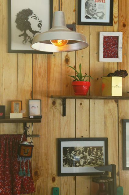 Cozy Interior Cafe Design with Framed Art and Rustic Wooden Wall - Download Free Stock Images Pikwizard.com