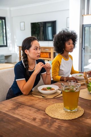 Diverse Friends Dining Together with Pasta and Drinks at Home
