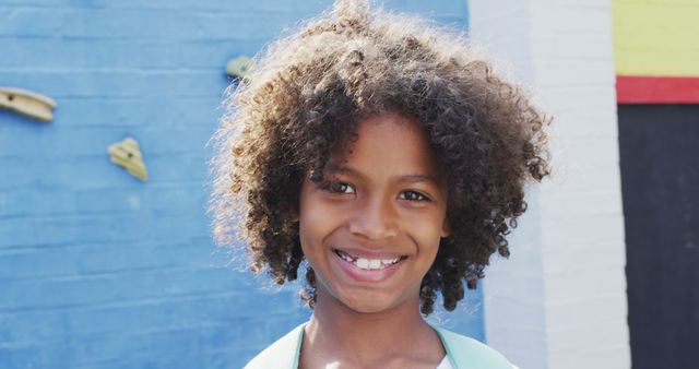 Happy Child with Curly Hair Smiling Outdoors - Download Free Stock Images Pikwizard.com