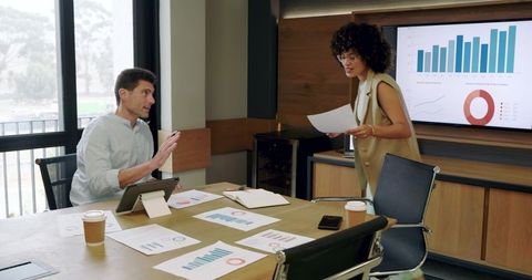 Business Team Reviewing Reports During Office Meeting