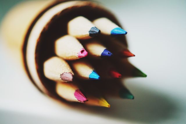 Close view of multicolored pencils arranged together with sharp tips in focus. Perfect for themes relating to art, creativity, education, and stationery. Can be used in designs for school materials, art classes, and hobby-related content.