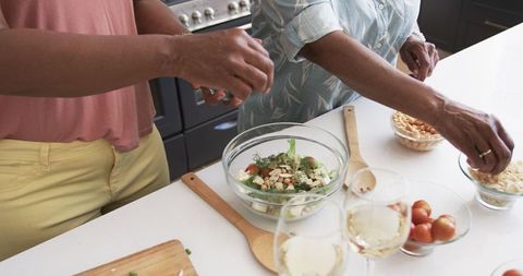 Senior African American Women Making Salad Together at Home Kitchen