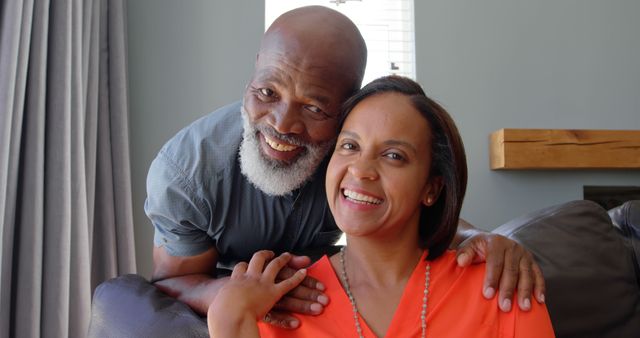 Front view of mature black couple looking at camera in a comfortable home. Portrait of happy couple 4k