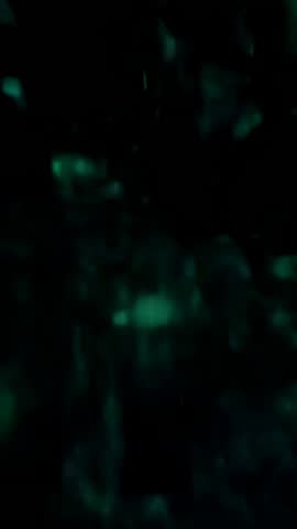 Vertical Nebula Burst Fragmenting Green-Blue Starfield Loop for Sci-Fi Motion Background