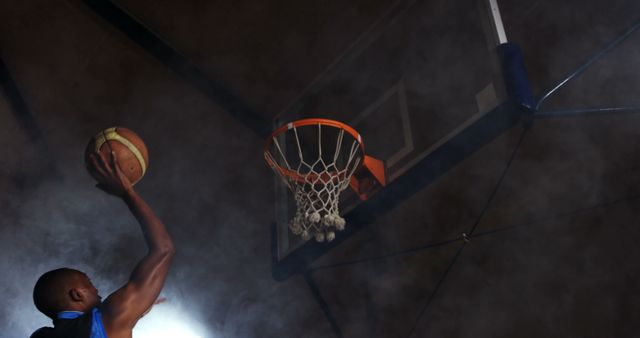 Athlete dunking basketball in smoke-filled arena - Download Free Stock Images Pikwizard.com