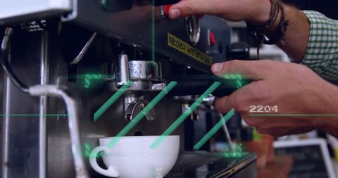 Barista preparing espresso shot with portafilter over cup closeup on chrome espresso machine