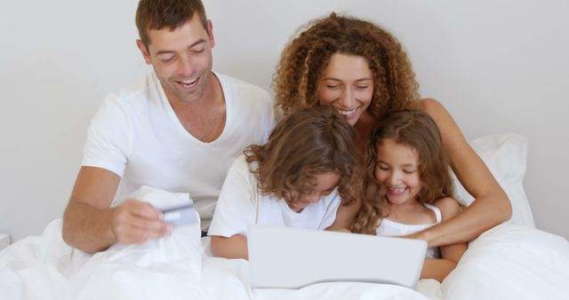 Happy Family Shopping Online While Relaxing in Bed - Download Free Stock Images Pikwizard.com