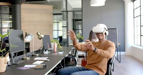 Enthusiastic professional experiencing virtual reality in office