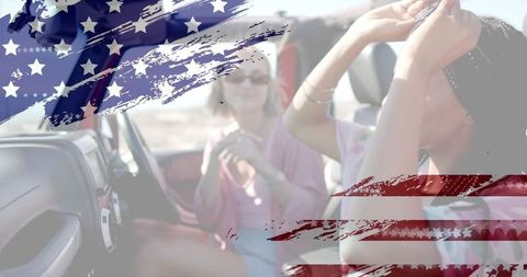 Friends cruising convertible under american flag brush strokes on sunlit coastal roadtrip
