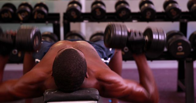 Man Lifting Dumbbells in Gym with Focused Intensity - Download Free Stock Images Pikwizard.com