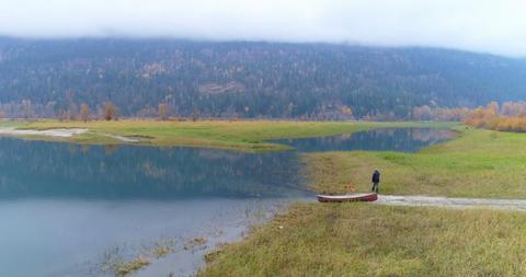 Solitary Man with Canoe by Serene Mountain Lake - Download Free Stock Images Pikwizard.com