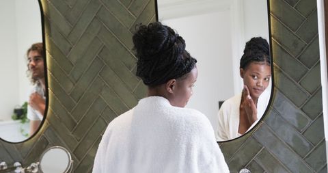 Young african american woman exploring skincare routine at home