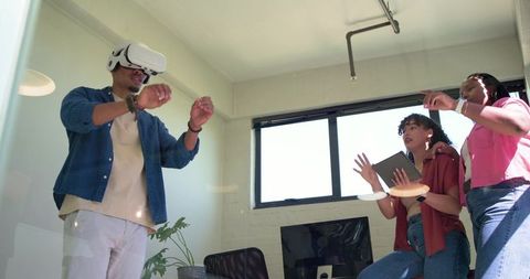 African american team testing vr collaboration tool in bright modern office workspace