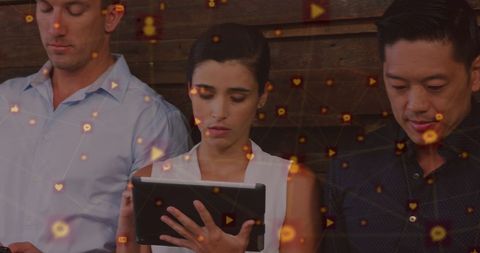 Diverse Team Using Tablets with Digital Media Overlay