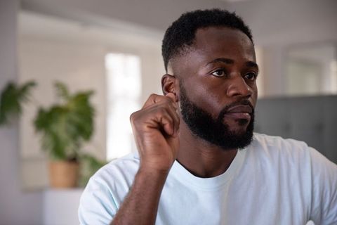 Pensive Man Reflecting in Modern Living Room