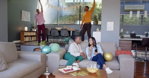 Friends Gather Decorating Modern Living Room for Festive Birthday Celebration