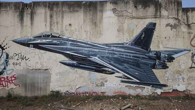 Urban fighter jet mural on weathered wall with graffiti