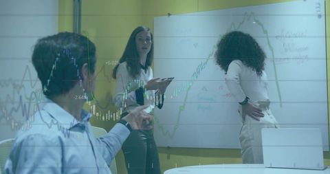 Diverse Business Team Analyzing Financial Trends on Whiteboard