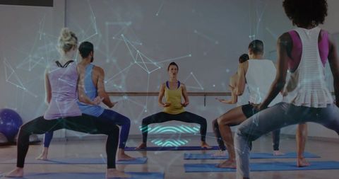 Leading Fitness Coach Guiding Wide Squat Class with Futuristic Digital Overlay in Studio
