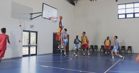 Intense basketball dunk in motion on indoor court