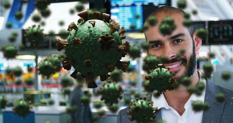 Businessman at Airport Surrounded by Digital Coronavirus Graphics