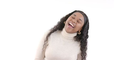 Joyful Woman Laughing in Cozy Turtleneck on White Background
