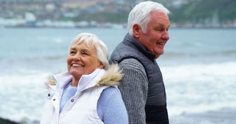 Senior Couple Smiling Joyfully by Seaside in Winter Clothes - Download Free Stock Images Pikwizard.com