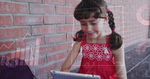 Young girl using tablet by brick wall with tech overlays, digital learning and data concept