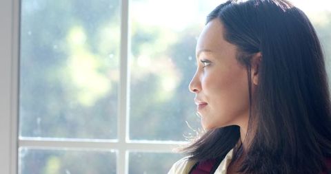 Asian Woman Gazing Out Window Embracing Mindfulness