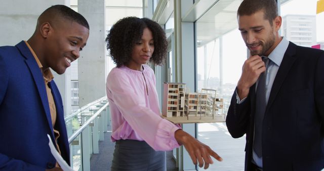 Diverse Business Team Discussing Architectural Model in Modern Office - Download Free Stock Images Pikwizard.com