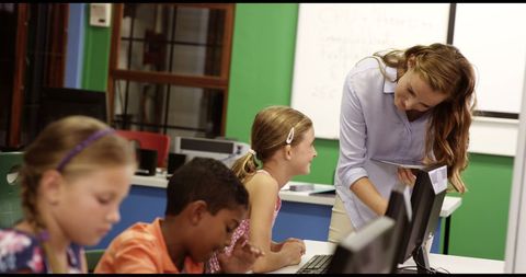 Teacher Guiding Engaged Students Using Computers in Modern Classroom - Download Free Stock Images Pikwizard.com