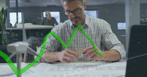 Businessman Analyzing Financial Chart in Modern Office Space