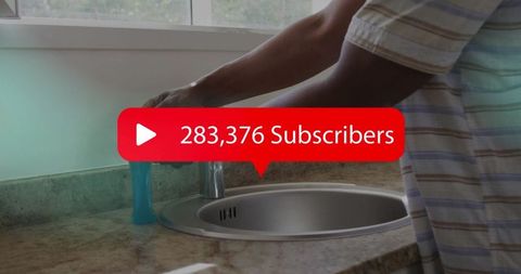 Man in casual kitchen with digital subscriber counter