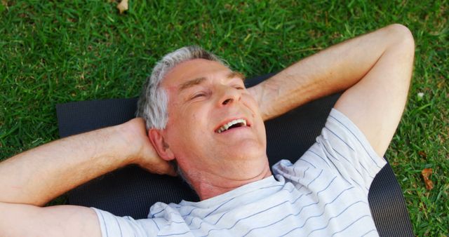 Senior Man Relaxing on Grass with Hands Behind Head and Smiling - Download Free Stock Images Pikwizard.com