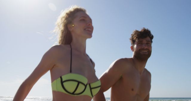 Young Couple Enjoying Sunny Day at Beach Together - Download Free Stock Images Pikwizard.com