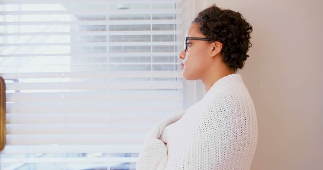 Pensive Woman Standing by Window Comforting Wrapped in Blanket - Download Free Stock Images Pikwizard.com