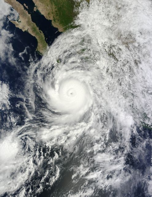 At about 10:45 p.m. Mountain Daylight Time (MDT) on September 14, 2014, Hurricane Odile made landfall as a Category 3 storm near Cabo San Lucas, Mexico. According to the U.S. National Hurricane Center, Odile arrived with wind speeds of 110 knots (204 kilometers or 127 miles per hour). The storm tied Olivia (1967) as the strongest hurricane to make landfall in the state of Baja California Sur in the satellite era.  The Moderate Resolution Imaging Spectroradiometer (MODIS) on NASA’s Terra satellite acquired this natural-color view of the storm at about noon MDT on September 14, when it was still southeast of the Baja California peninsula. Unisys Weather reported that the Category 4 storm had maximum sustained wind speeds of 115 knots (213 kilometers per hour) at the time.  Odile had weakened to a Category 2 hurricane by 6 a.m. MDT on September 15. The storm was expected to continue weakening as it moved up the peninsula and over the area’s rough terrain, according to weather blogger Jeff Masters. Meteorologists noted that while damaging winds posed the biggest threat in the short term, inland areas of the U.S. Southwest could face heavy rainfall by September 16. The rain expected from Odile came one week after the U.S. Southwest experienced flash floods from the remnants of Hurricane Norbert. According to weather and climate blogger Eric Holthaus, those floods did little to relieve the area’s ongoing drought.  NASA image by Jeff Schmaltz, LANCE/EOSDIS Rapid Response. Caption by Kathryn Hansen.  Instrument(s):  Terra - MODIS  Read more: <a href="http://earthobservatory.nasa.gov/IOTD/view.php?id=84378&amp;eocn=home&amp;eoci=iotd_title" rel="nofollow">earthobservatory.nasa.gov/IOTD/view.php?id=84378&amp;eocn...</a>  <b><a href="http://www.nasa.gov/audience/formedia/features/MP_Photo_Guidelines.html" rel="nofollow">NASA image use policy.</a></b>  <b><a href="http://www.nasa.gov/centers/goddard/home/index.html" rel="nofollow">NASA Goddard Space Flight Center</a></b> enables NASA’s mission through four scientific endeavors: Earth Science, Heliophysics, Solar System Exploration, and Astrophysics. Goddard plays a leading role in NASA’s accomplishments by contributing compelling scientific knowledge to advance the Agency’s mission. <b>Follow us on <a href="http://twitter.com/NASAGoddardPix" rel="nofollow">Twitter</a></b> <b>Like us on <a href="http://www.facebook.com/pages/Greenbelt-MD/NASA-Goddard/395013845897?ref=tsd" rel="nofollow">Facebook</a></b> <b>Find us on <a href="http://instagram.com/nasagoddard?vm=grid" rel="nofollow">Instagram</a></b>