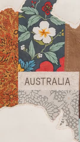 Vertical video focusing on Australia patchwork map with embroidered AUSTRALIA label