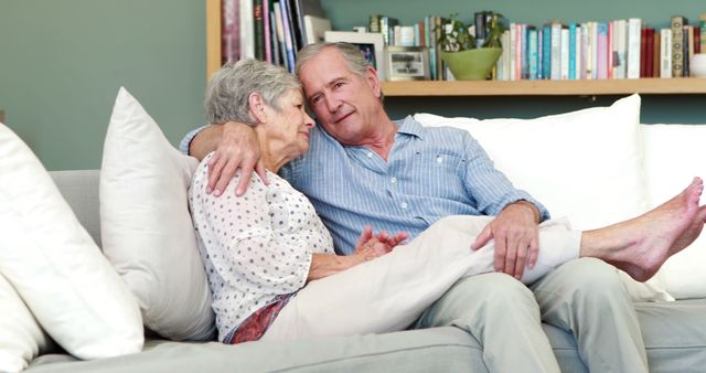 Senior couple embracing in living room at home