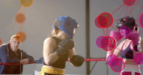 Female Boxers Sparring in Ring Wearing Headguards and Gloves with Data Graphics