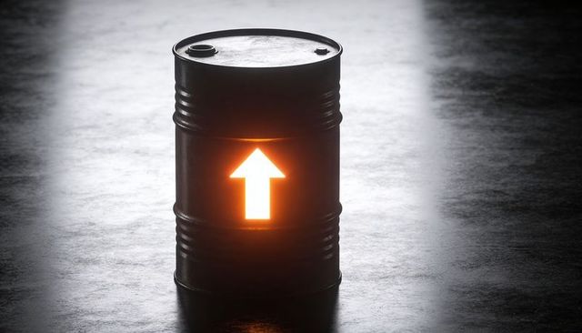 Glowing Industrial Barrel Emitting Upward Arrow of Orange Light on Dark Concrete Floor