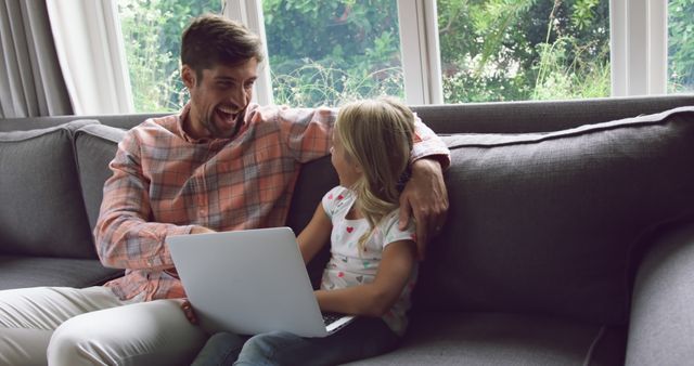 Father and Daughter Using Laptop on Couch Smiling - Download Free Stock Images Pikwizard.com