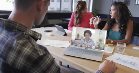 Diverse Team Engaged in Virtual Meeting in Modern Office