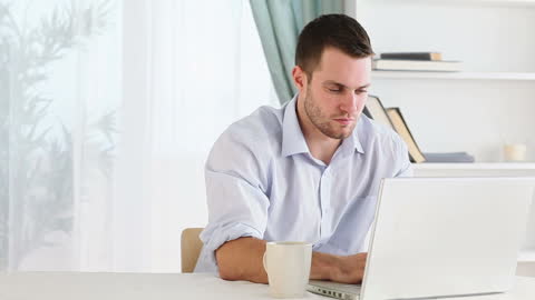 Young Professional Working on Laptop from Home