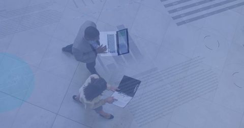 Overhead View of Business Professionals with Data Graphics