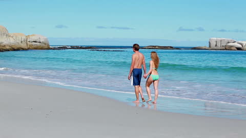 Romantic Couple Walking on Secluded Beach