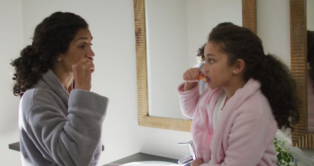 Mother and Daughter Brushing Teeth in Bathroom Mirror - Download Free Stock Images Pikwizard.com