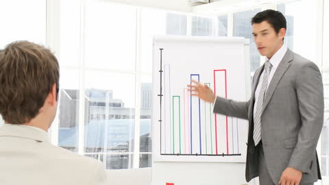 Businessman Delivering Presentation with Growth Chart in Office