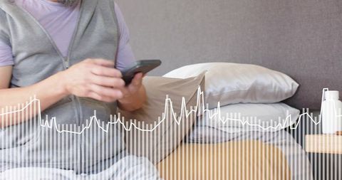 Asian man checking smartphone on bed with sleep data waveform overlay for wellness apps